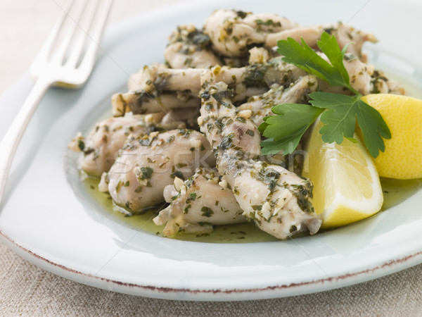 Stock photo: Frogs Legs Fried in Garlic and Herb Butter with Lemon