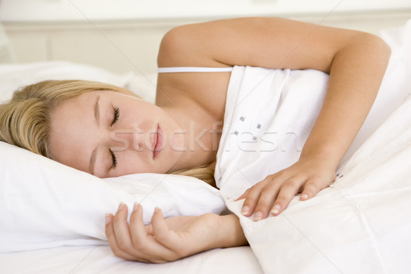 Stock photo: Woman lying in bed sleeping