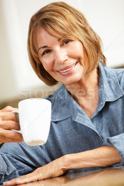 Mid age woman drinking coffee Stock photo © monkey_business