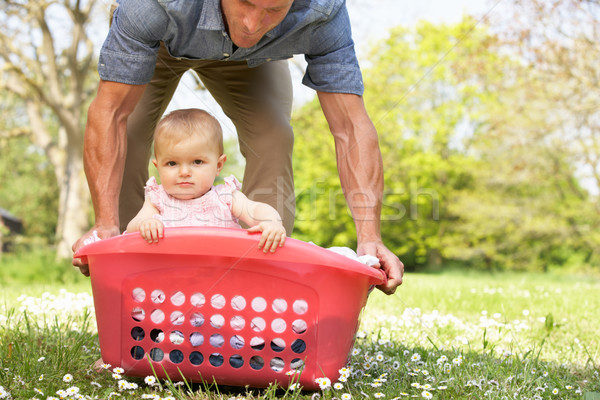 Father Carrying Baby Girl Sitting In Laundry Basket Stock photo © monkey_business