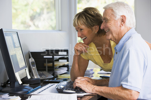 Couple bureau à domicile ordinateur paperasserie souriant internet Photo stock © monkey_business