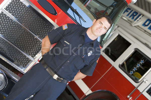 Portrait of a firefighter by a fire engine Stock photo © monkey_business