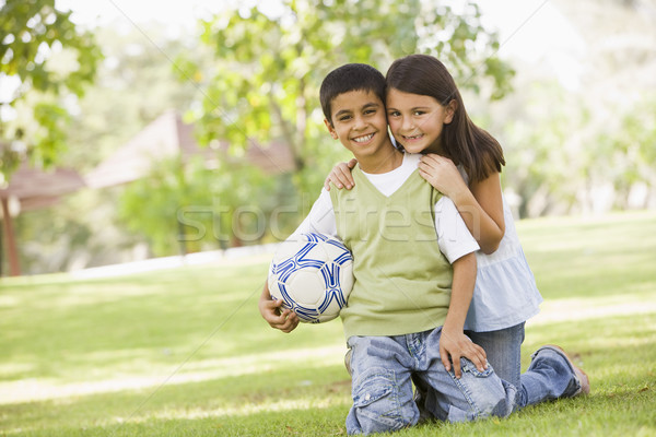 Two Children Playing Football In Park Stock Photo C Monkey