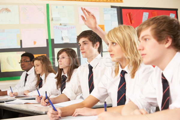 Teenage Student Answering Question Studying In Classroom Stock photo © monkey_business