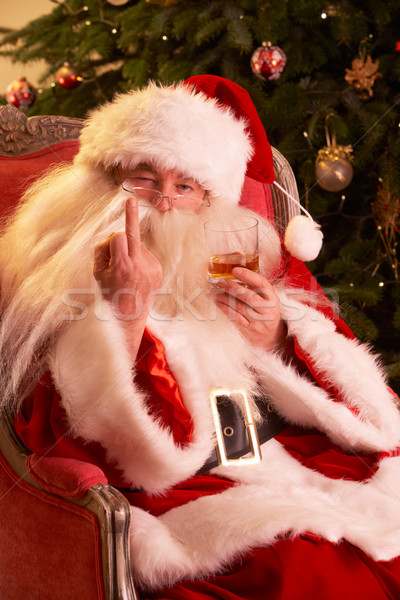 Santa Claus Making Rude Gesture To Camera In Front Of Christmas  Stock photo © monkey_business
