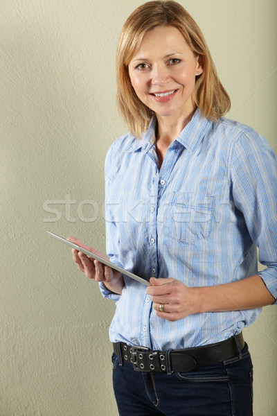 Studio Shot Of Middle Aged Woman Using Tablet Computer Stock photo © monkey_business