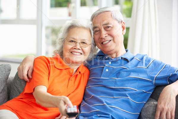 Senior Chinese Couple Watching TV On Sofa At Home Stock photo © monkey_business
