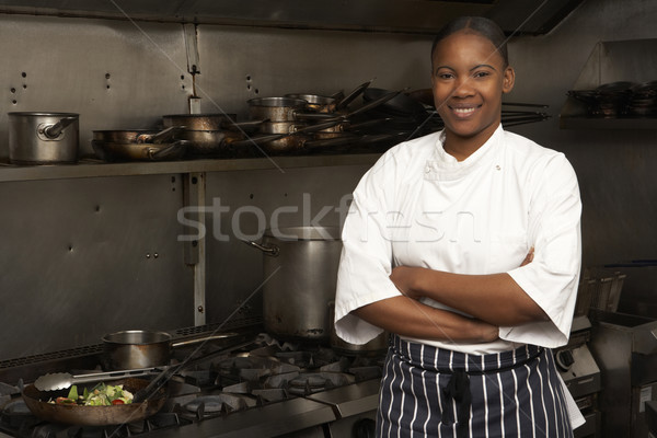 Stock photo: Female Chef Standing Next To Cooker In Restaurant Kitchen