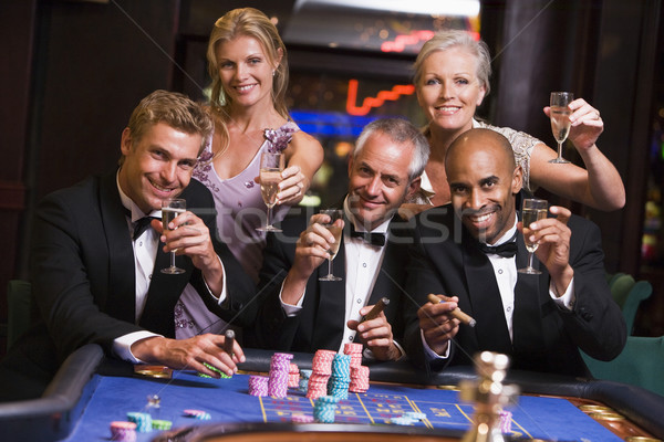Groupe amis jeux roulette table femme [[stock_photo]] © monkey_business