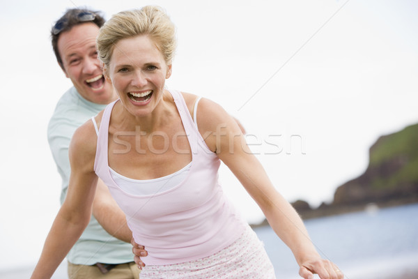 Couple at the beach smiling Stock photo © monkey_business