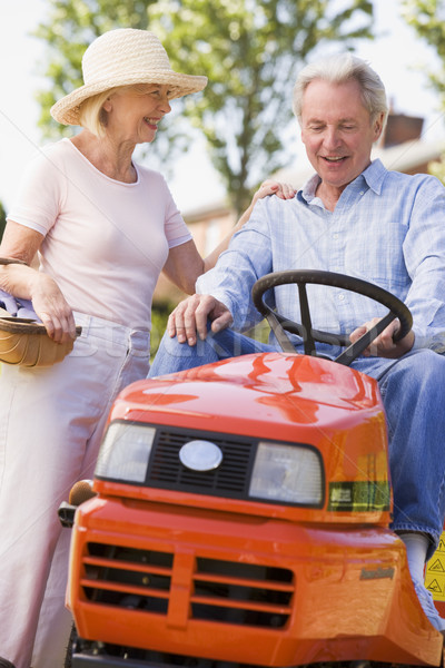 Couple outdoors with tools and lawnmower smiling Stock photo © monkey_business