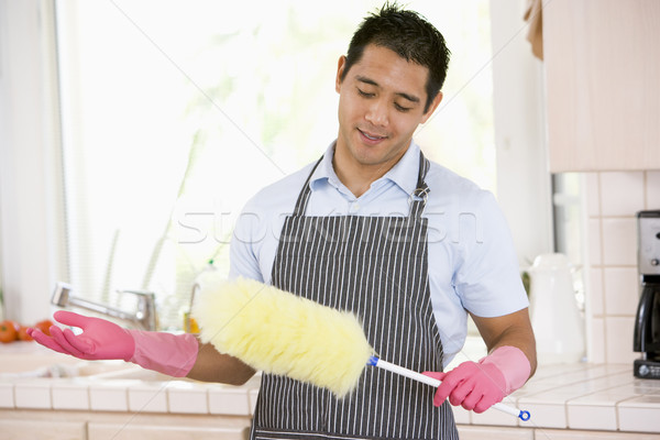 Man Holding Duster And Wearing Rubber Gloves Stock photo © monkey_business