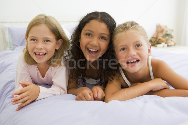 Three Young Girls Lying On A Bed In Their Pajamas Stock photo © monkey_business