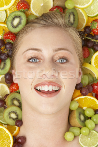 Portrait Of Young Woman Surrounded By Fruit Stock photo © monkey_business