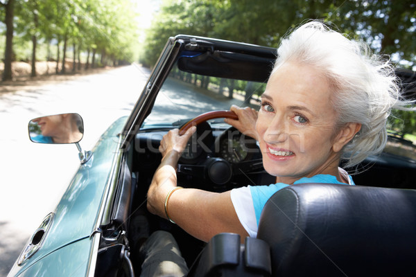 Stock photo: Senior woman in sports car