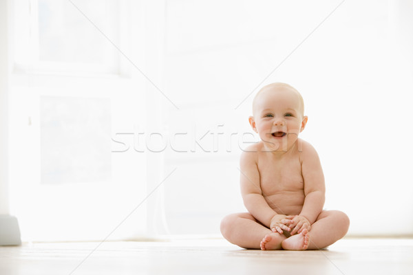 Baby sitting indoors smiling Stock photo © monkey_business