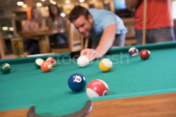 Junger Mann spielen Pool bar Schwerpunkt Billardtisch Stock foto © monkey_business