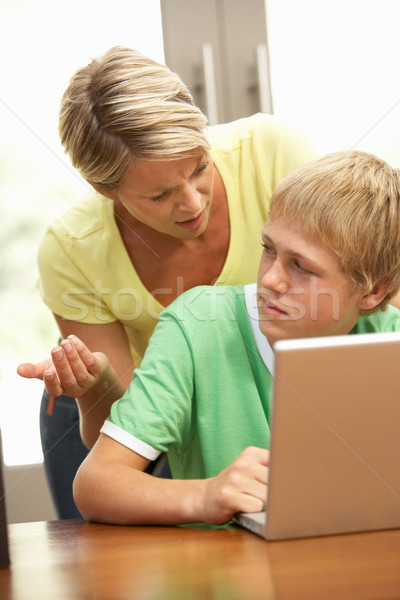 Mérges anya tini fiú laptopot használ otthon Stock fotó © monkey_business