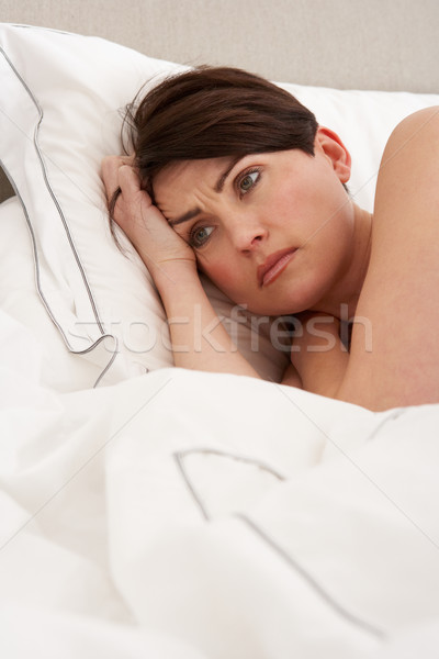 Zmartwiony kobieta obudzić bed sypialni Zdjęcia stock © monkey_business