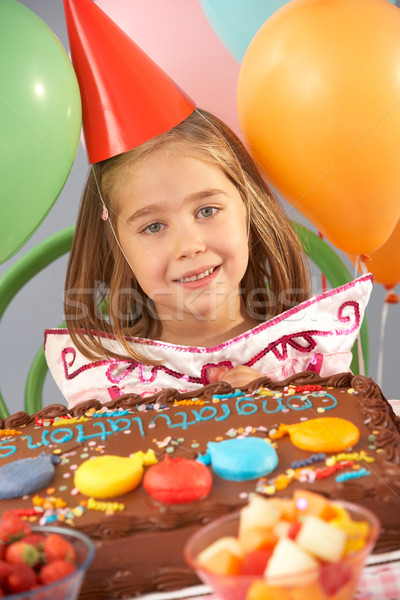 Stock photo: Young girl with birthday cake at party