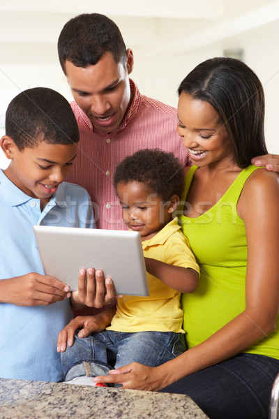 Stock photo: Family Using Digital Tablet In Kitchen Together