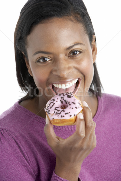 Mujer toma morder buñuelo estudio sonriendo Foto stock © monkey_business