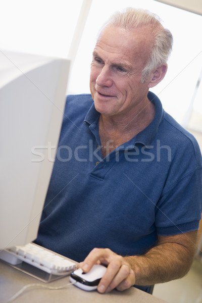 Stock photo: Mature male student learning computer skills