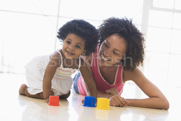 Mother and daughter indoors playing and smiling Stock photo © monkey_business