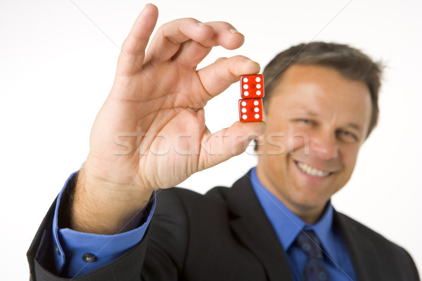 Stock photo: Businessman Holding Two Red Dice 