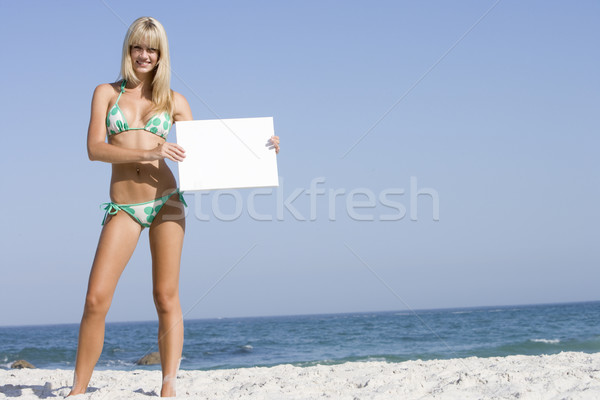 Stock photo: Woman on beach holding blank card