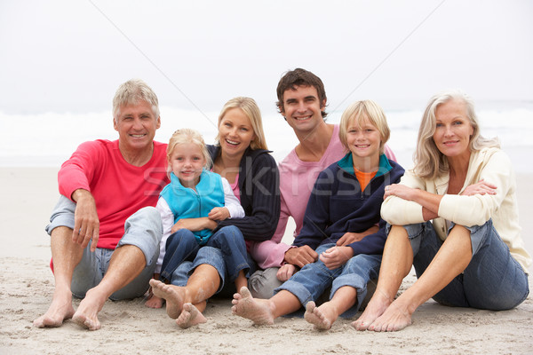 Three Generation Family Sitting On Winter Beach Together Stock photo © monkey_business