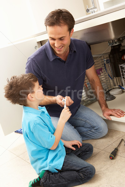 Son Helping Father To Mend Sink In Kitchen Stock photo © monkey_business