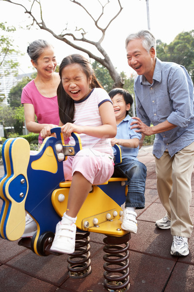 Stock photo: Chinese Grandparents Playing With Grandchildren In Playground