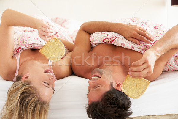 Couple Snuggled Under Duvet Eating Breakfast Stock photo © monkey_business