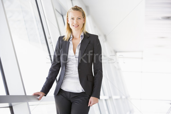 Businesswoman standing in corridor smiling Stock photo © monkey_business