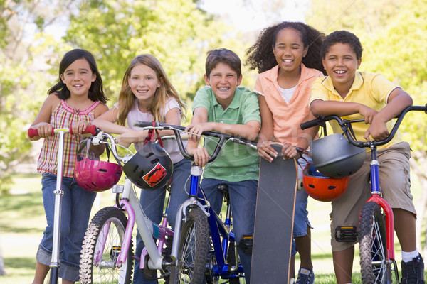 Five young friends with bicycles scooters and skateboard outdoor Stock photo © monkey_business
