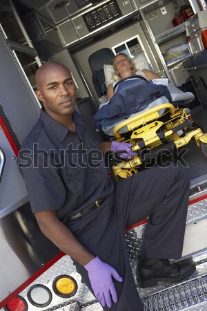Paramedics preparing to unload patient on gurney Stock photo © monkey_business