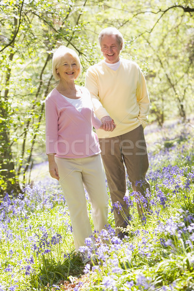 Couple walking outdoors holding hands smiling Stock photo © monkey_business