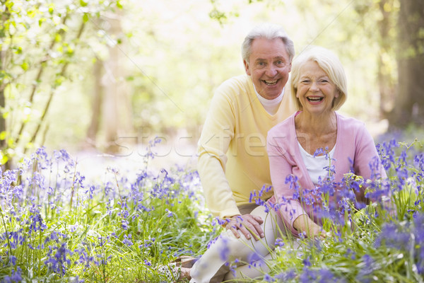 Couple sitting outdoors with flowers smiling Stock photo © monkey_business
