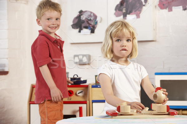 Car salesman sitting in showroom Stock photo © monkey_business