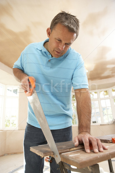 Builder Sawing Wood On Workbench Stock photo © monkey_business