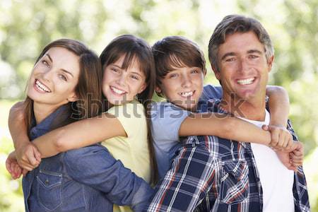 Family Group Outdoors In Autumn Landscape With Parents Giving Ch Stock photo © monkey_business