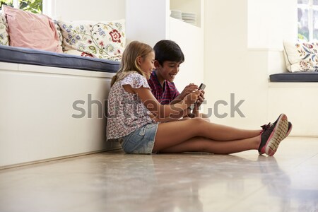 Two Girlfriends Taking Photo With Digital Camera In Modern Kitch Stock photo © monkey_business