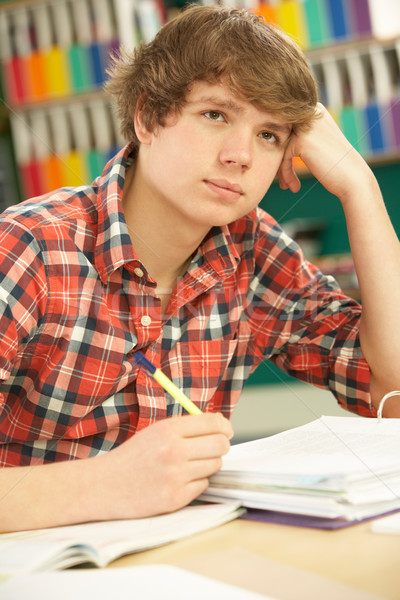 Stressed Male Teenage Student Studying In Classroom Stock photo © monkey_business
