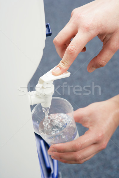 Woman filling cup at water cooler Stock photo © monkey_business
