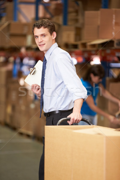 Businessman Pulling Pallet In Warehouse Stock photo © monkey_business