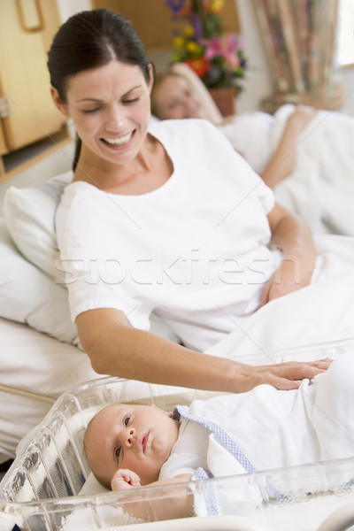 Stock photo: Pregnant mother with baby in hospital smiling