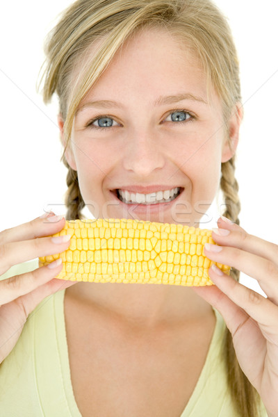 Teenage girl holding corn on cob and smiling Stock photo © monkey_business