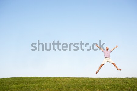 Senior woman  jumping in air Stock photo © monkey_business