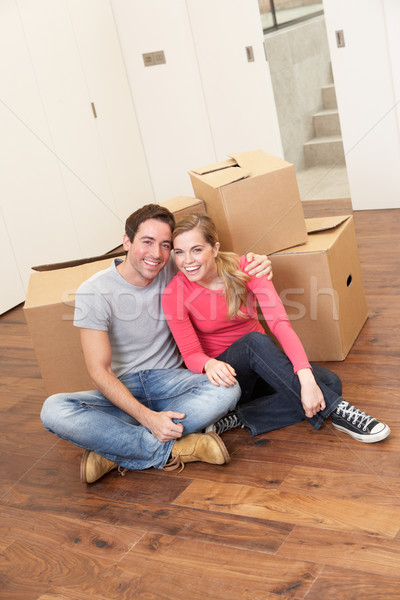 Young couple on moving day sitting with cardboard boxes Stock photo © monkey_business